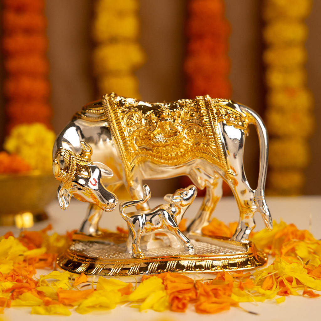Decorative Gold and Silver Kamdhenu Cow with Flowers in the background