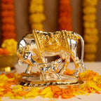 Decorative Gold and Silver Kamdhenu Cow with Flowers in the background